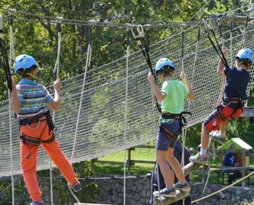 Boys crossing the adventure path at Elias Adventure Park near Lake Garda.