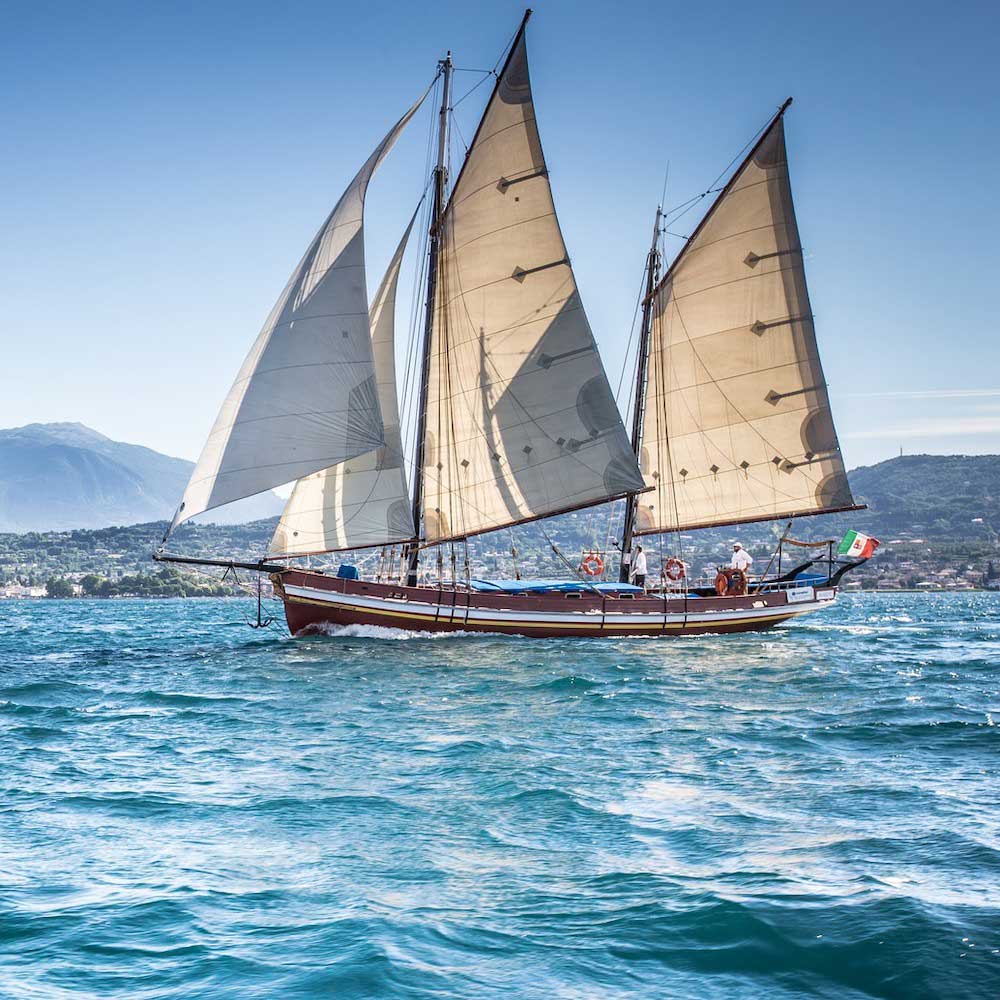 Vintage sailing ship cruising on Lake Garda.