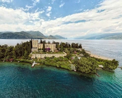 Aerial view showcasing Isola del Garda in the center of Lake Garda.